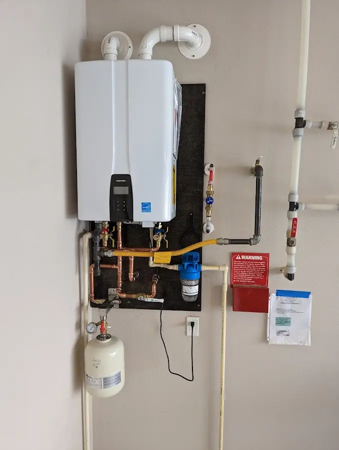 Professional plumber installing copper piping in a Aberdeen home